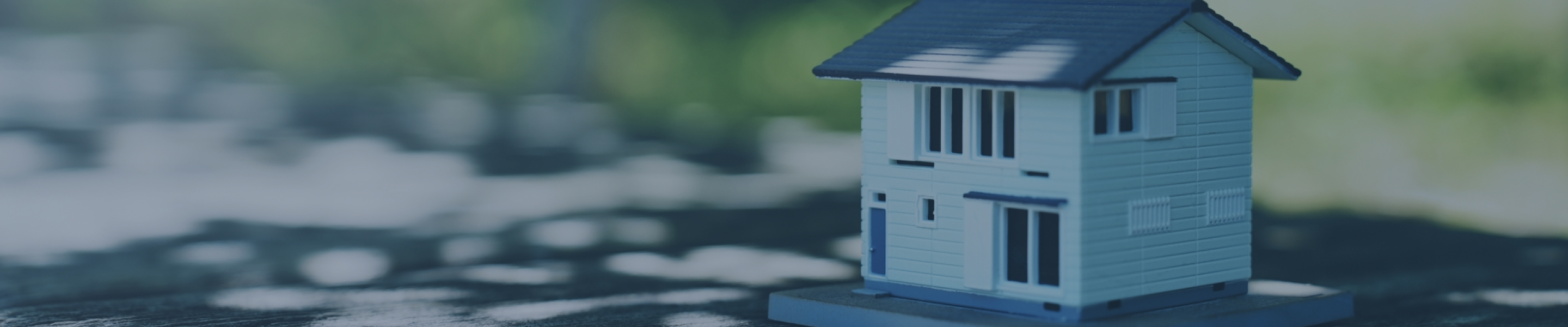 空をバックに屋根の上にヘルメットを被った作業員が立っている